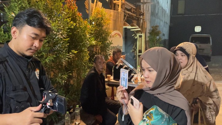 Jemaah sedang melakukan absen digital jelang sholat tarawih berjamaah, Rabu 5 Maret 2025.